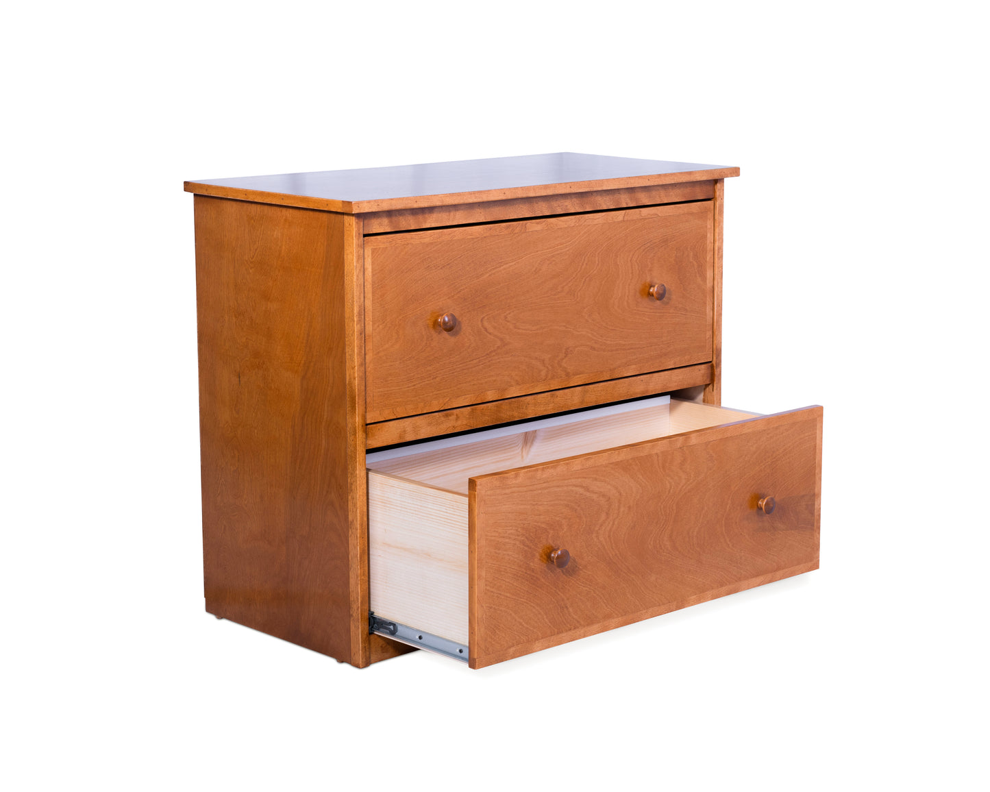 Angled view of a two drawer lateral file cabinet built in birch with wood knobs, in a light brown stain color, and the bottom drawer pulled out.