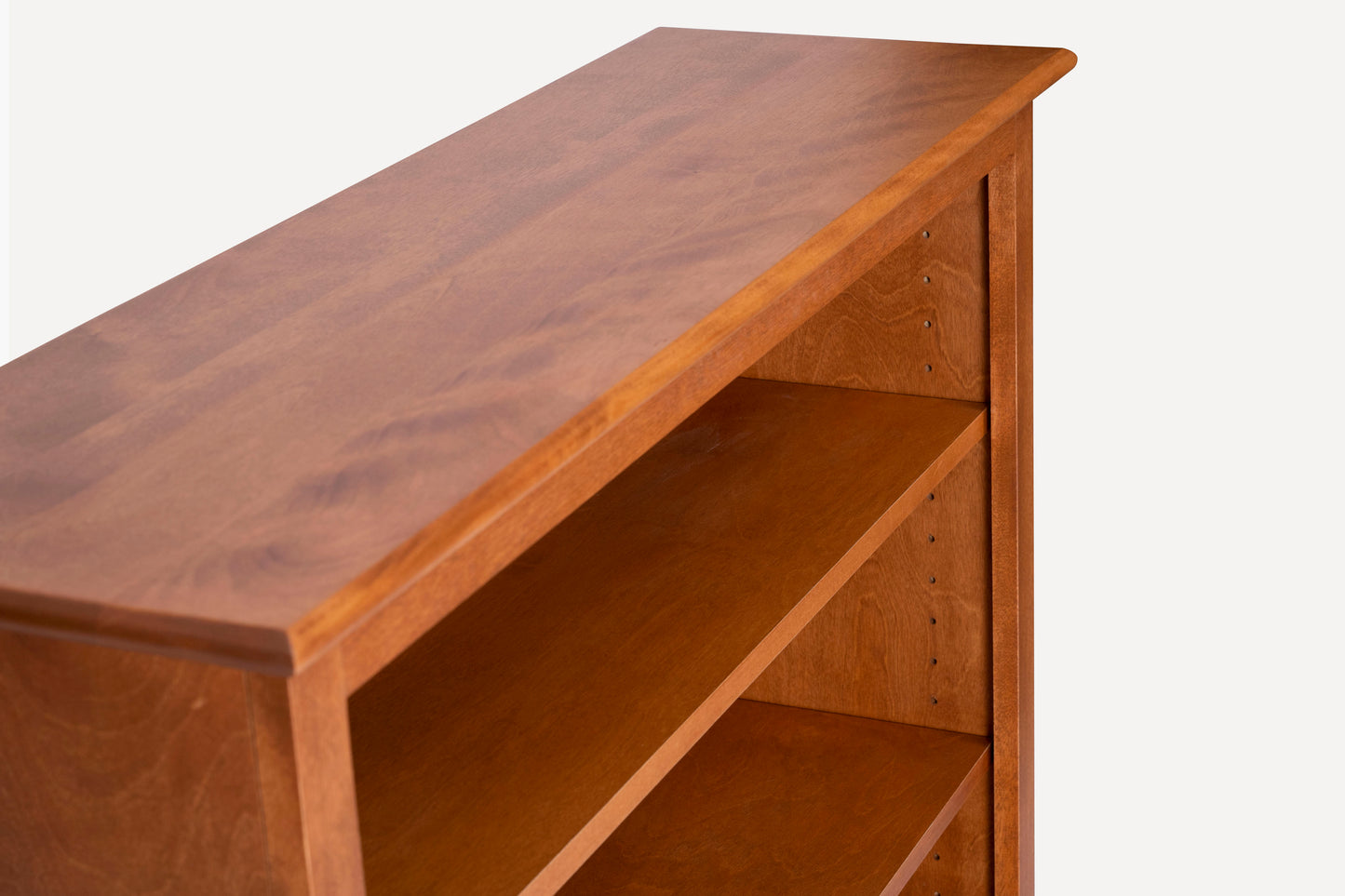 Acadia Cottage Bookcases: A rustic, nutmeg-finished design with 12" depth, perfect for small spaces, adds charm to any room. Shelving is adjustable.