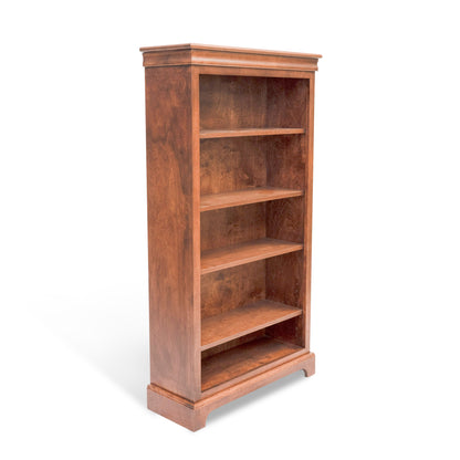 Acadia Madison Bookcase is built in birch and is 12 inches deep, featuring adjustable shelving and crown moulding. Shown in Walnut finish from a side angle.