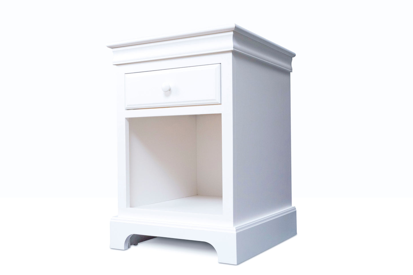 Acadia Madison One Drawer Nightstand with one full extension drawer and a cubby space underneath. Features crown molding and pictured from front angle in white.