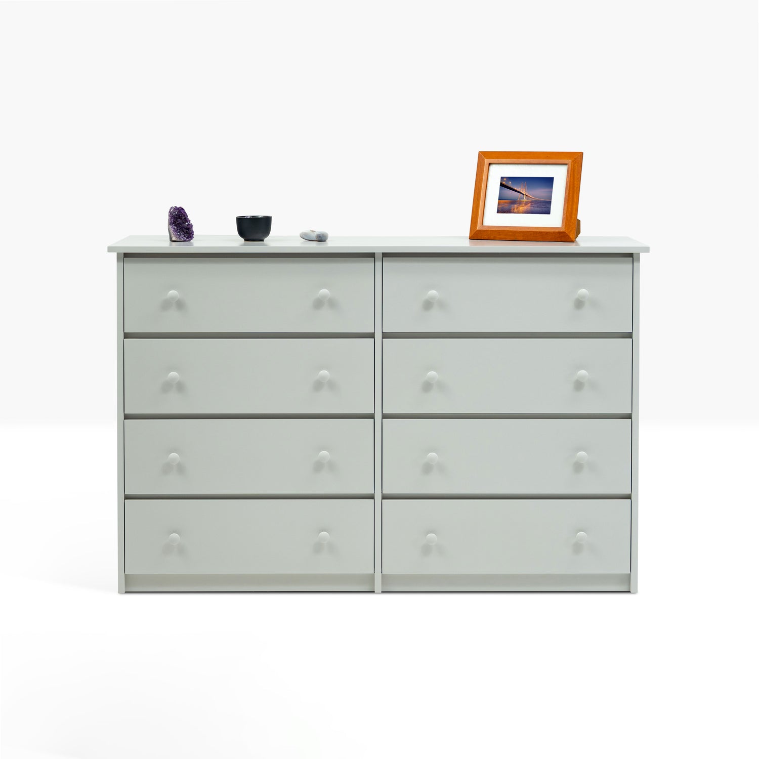Eight drawer dresser with wood knobs shown from the front in light gray paint color.