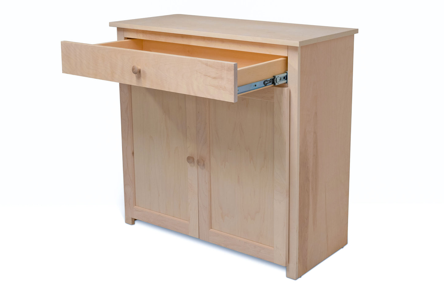 Berkshire Easton Cabinet with Drawer shown in unfinished birch with the drawer open to show storage space. 