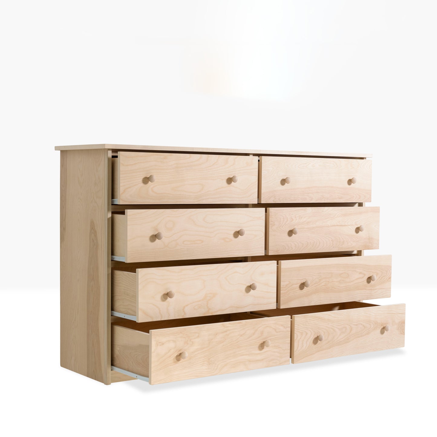 Evergreen Dresser is constructed from pine and birch and is shown with eight drawers. Pictured with drawers open to show storage capacity.