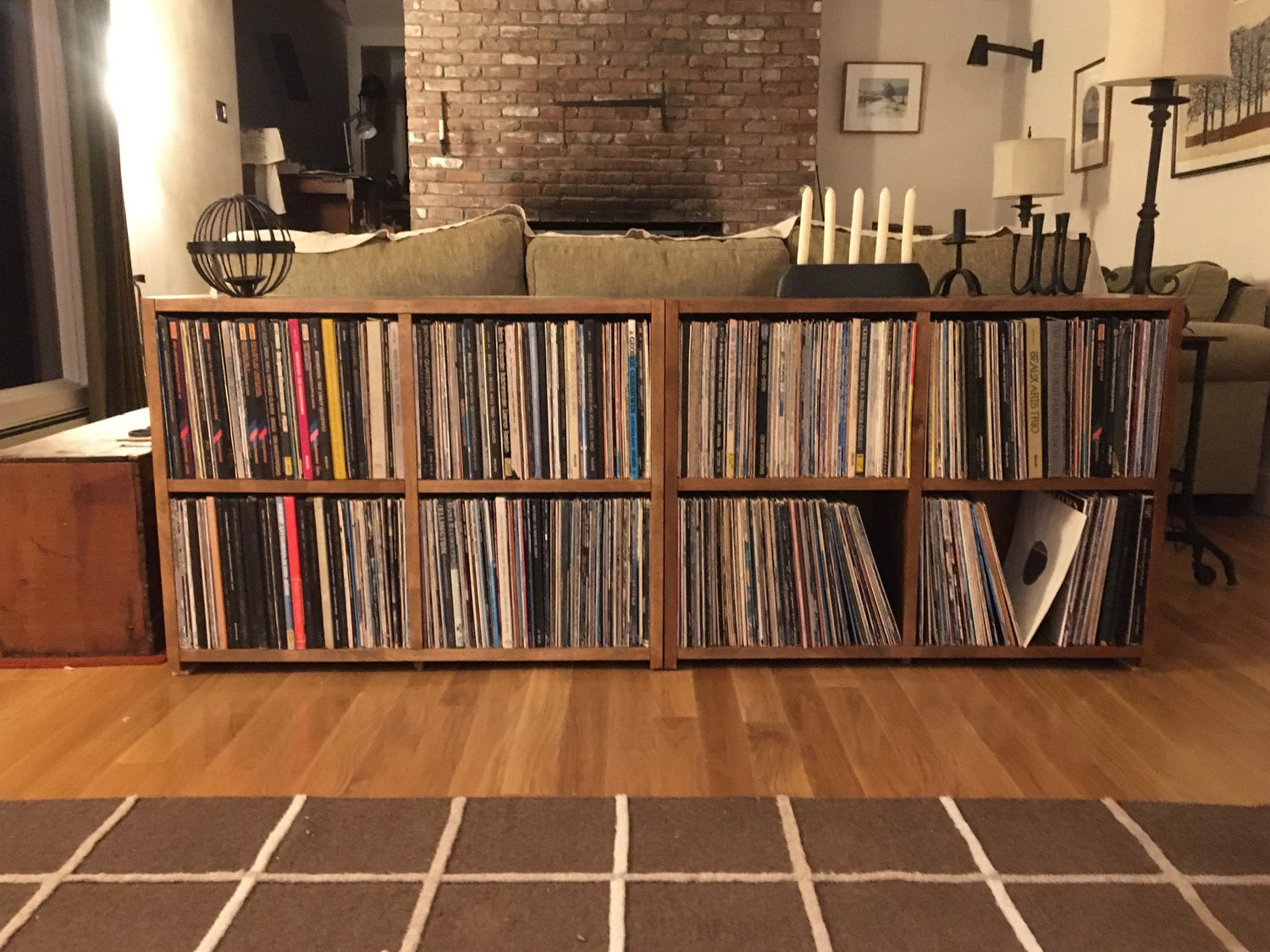 Two bookcases built in birch holding records and LPs finished in a light brown stain.