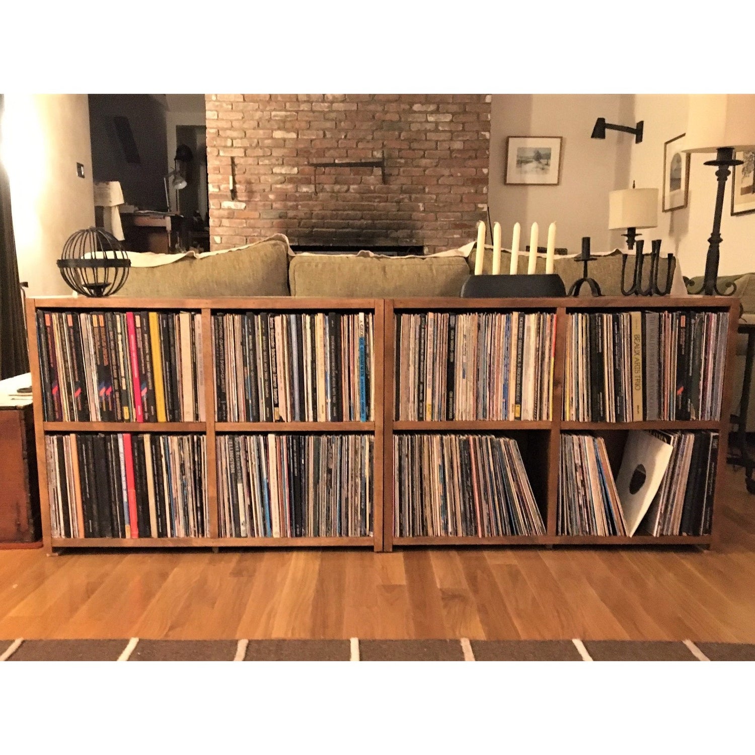 Low shelf and bookcase storage for LPs and record albums in birch with a stain shown from the front.