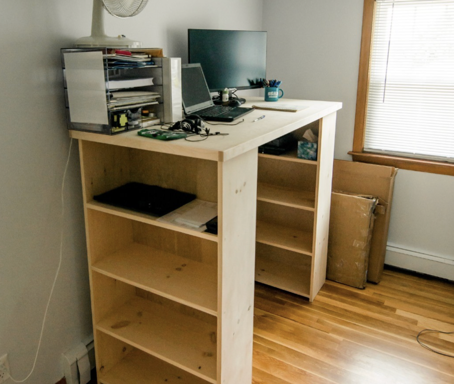 Unfinished standing desk with bookcases for base supports built in pine.