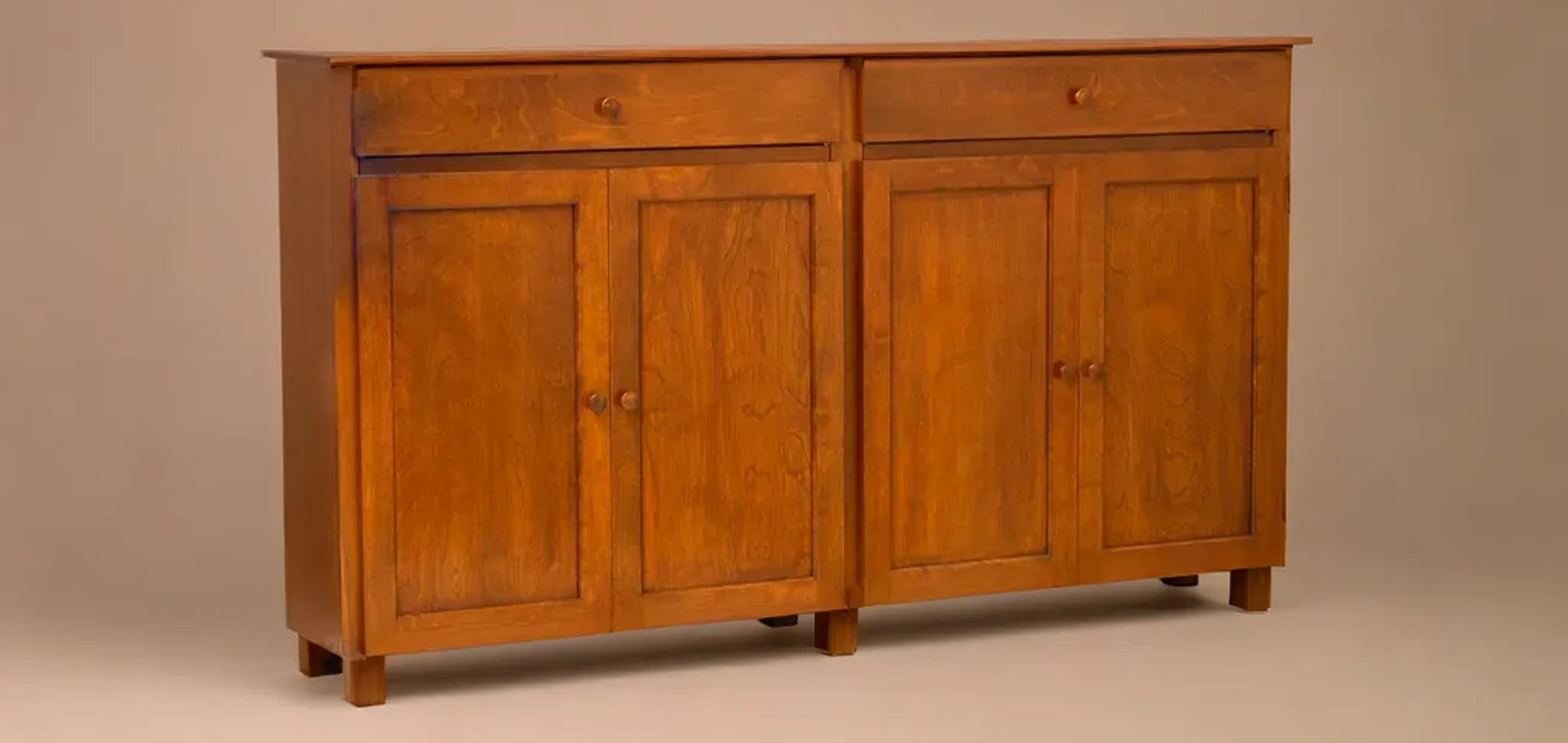 Buffet cabinet with four doors, two drawers, and small square legs in birch wood and stained shown from the front.