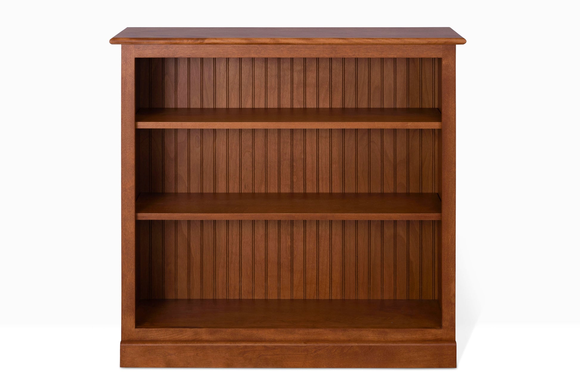 Acadia Cottage Bookcases: Compact and charming with a nutmeg finish and rustic design, ideal for small spaces at 12" depth. Shelving is adjustable.