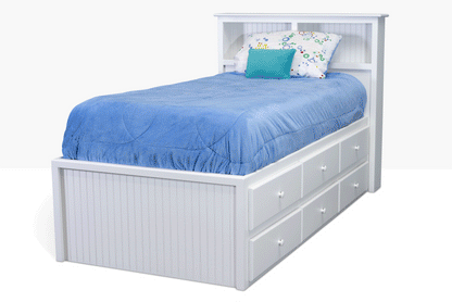 Acadia Cottage Storage Bed with 6 drawers on one side and a book case headboard for storage. Pictured in white. Shown from the side with drawers open to highlight the storage space.