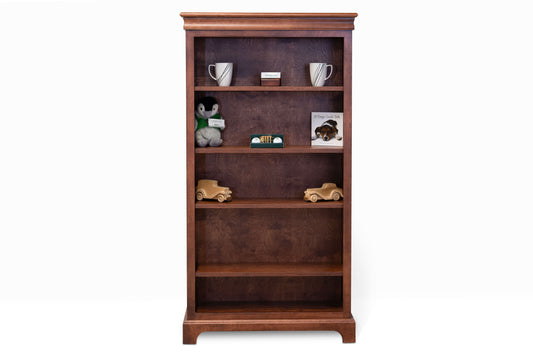 Acadia Madison Bookcase is built in birch and is 12 inches deep, featuring adjustable shelving and crown moulding. Shown in Walnut finish.