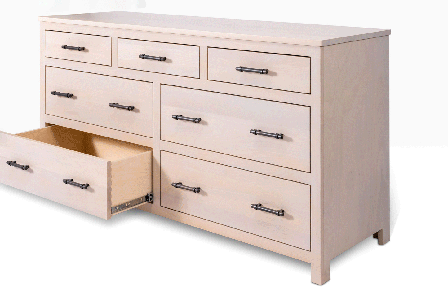 Acadia Tremont Seven Drawer Dresser features four large drawers and three small drawers on the top row. Pictured in Sandstone Finish with drawer open to show storage space.