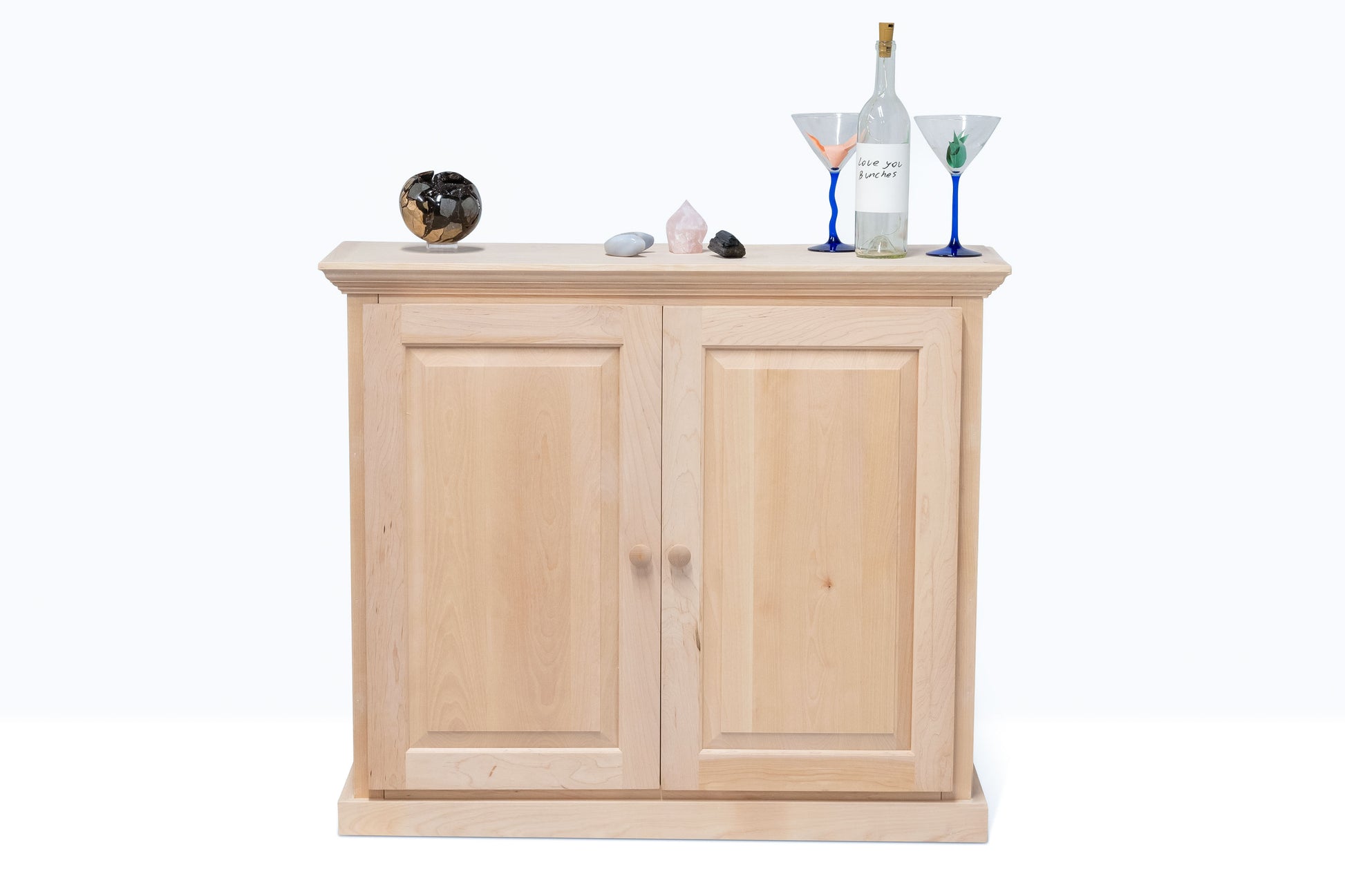 Berkshire Dover Cabinet built in birch, shown unfinished with items on it.